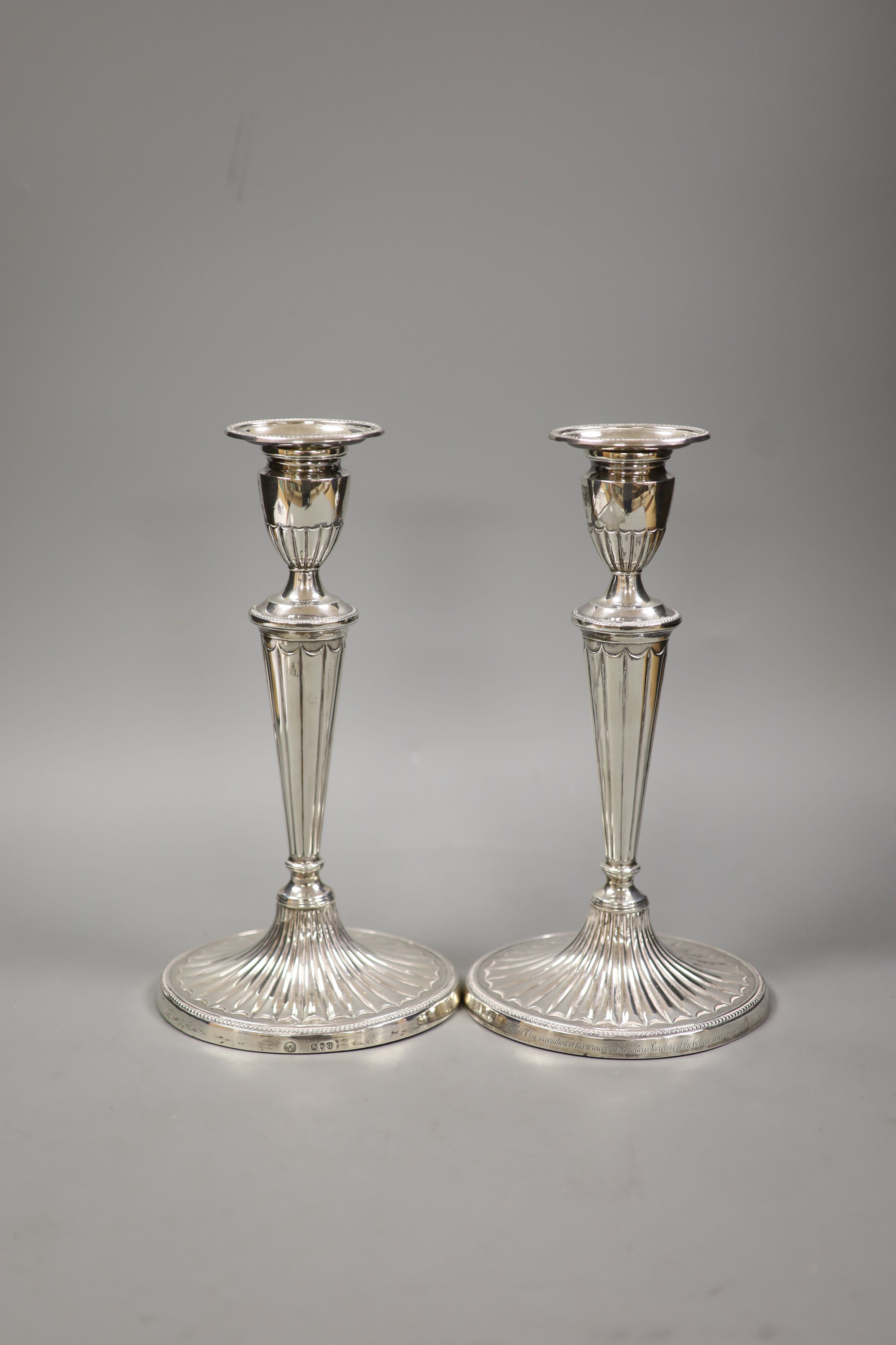 A pair of late Victorian silver oval candlesticks, with engraved inscription, Charles Stuart Harris Junior, London, 1891, height 28.8cm, weighted (repair).